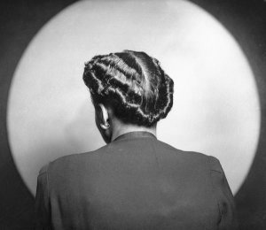 Charles "Teenie" Harris - Portrait of woman modeling short waved hairstyle, seen from behind, in Harris Studio, ca. 1938-1945