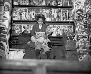 Charles "Teenie" Harris - Girl reading "Mickey Mouse and the Submarine Pirates" comic book, Hill District, Pittsburgh, 1947