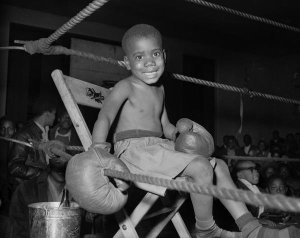 Charles "Teenie" Harris - Little boy boxer seated in boxing ring, possibly in Kay Boys' Club, ca. 1945
