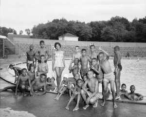 Charles "Teenie" Harris - Singer Carol Thompson posing with boys, at Sully's Pool in South Park during Pittsburgh Courier newsboys picnic, 1961