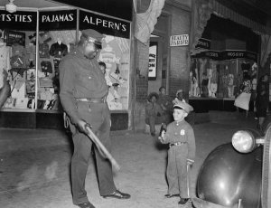 Charles "Teenie" Harris - Small boy in police uniform with police officer Prince "Big Blue" Bruce, Centre Avenue, Hill District, ca. 1938-1945