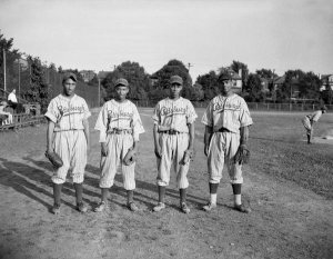 Charles "Teenie" Harris - Four Pittsburgh Crawfords baseball players, Peatross, Johnson, Daniels, and Atkins, standing on field, 1945