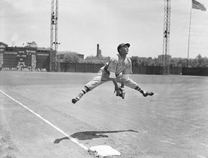 Charles "Teenie" Harris - New York Cubans baseball player Horacio Martinez leaping above third base at Forbes Field, 1941