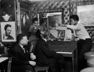 Charles "Teenie" Harris - Frank Bolden and Sarah Vaughan, with another woman and man at piano, in club, ca. 1950