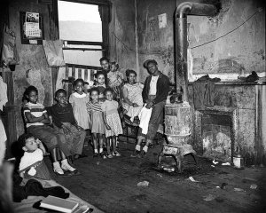 Charles "Teenie" Harris - Lillie Copeland and her family in their dilapidated home, Strip District, 1951