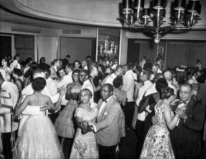 Charles "Teenie" Harris - Women and men dancing in couples, in Gateway Plaza ballroom, for FROGS formal, July 1959