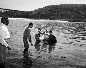 Charles "Teenie" Harris - Calvary Baptist Church deacons baptizing man in Allegheny River, 1969