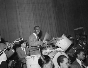 Charles "Teenie" Harris - Billy Eckstine Orchestra performing in Hill City Auditorium (Savoy Ballroom) with Art Blakey on drums, 1944