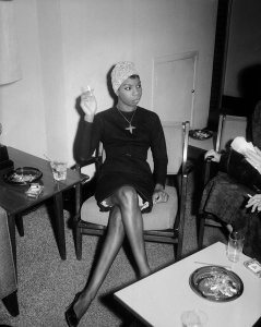 Charles "Teenie" Harris - Nina Simone holding cigarette and seated in chair, 1965