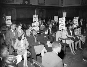 Charles "Teenie" Harris - Protestors with signs gathered in Pittsburgh City Council Chambers at the City County Building, 1949