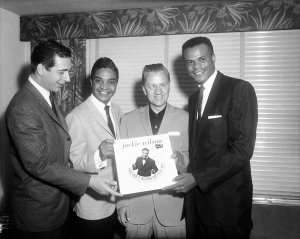 Charles "Teenie" Harris - Nat Tarnapol, Jackie Wilson, Porky Chedwick holding Jackie Wilson's "You Ain't Heard Nothin Yet" album, and Roy Hamilton at the Carleton House, 1961