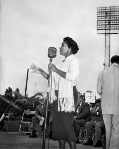Charles "Teenie" Harris - Velma Carey singing during "I am an American Day" celebration at Forbes Field, Oakland, 1952