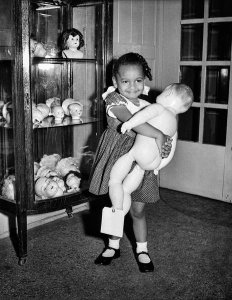 Charles "Teenie" Harris - Girl holding doll, possibly in Stevenson Doll Shop, ca. 1950-1960