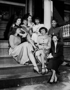 Charles "Teenie" Harris - Group portrait of eight Andante Club members seated on steps of brick building, April-May 1949