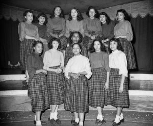 Charles "Teenie" Harris - Group portrait of twelve teenage girls from Kolesque Club wearing homemade plaid skirts and blouses, ca. 1950