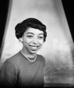 Charles "Teenie" Harris - Portrait of Joan Bruce wearing dark sweater and pearl necklace, in Harris Studio, 1950
