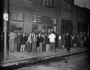 Charles "Teenie" Harris - Men and boys standing on sidewalk beside The Pittsburgh Courier building, c. 1946
