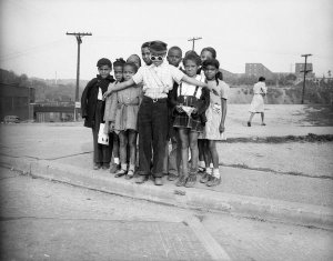 Charles "Teenie" Harris - Boy school crossing guard holding back group of children, A. Leo Weil School, Hill District, 1947